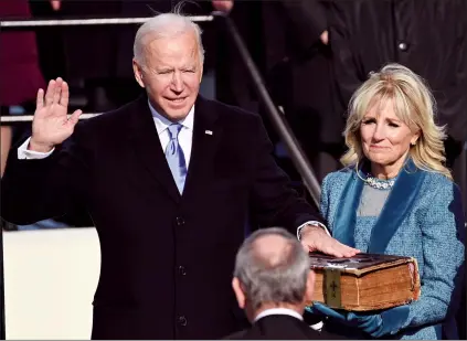  ?? AP PHOTO SAUL LOEB ?? Joe Biden is sworn in as the 46th president of the United States by Chief Justice John Roberts as Jill Biden holds the Bible during the 59th Presidenti­al Inaugurati­on at the U.S. Capitol in Washington on Wednesday.