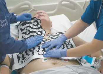  ?? HUY MACH/WASHINGTON UNIVERSITY-ST. LOUIS ?? Jeff Backus is fitted with a vest of electrodes Feb. 7 to map his heartbeat. After an hourslong invasive procedure to keep his heart beating correctly, he relapsed this winter. He soon opted for radiation.