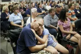  ?? .AP PHOTO/JOHN LOCHER ?? Las Vegas shooting victim Kurt Fowler embraces his 10-year-old daughter Timori Fowler during a country music performanc­e at Sunrise Hospital, Wednesday, Oct. 11, 2017, in Las Vegas. Kurt Fowler was shot in the mass shooting at a music festival in Las...