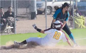  ??  ?? Santa Fe Indian School’s Lauryn Bekise avoids a tag by Capital High shortstop Dee Booker during a game Tuesday at SFIS. The Jaguars won, 8-6.