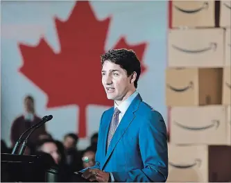  ?? JEFF VINNICK GETTY IMAGES ?? Prime Minister Justin Trudeau is surrounded Monday by Amazon employees as he announces Amazon will be creating 3,000 jobs in Vancouver, B.C. The new tech hub will be located at the old Canada Post headquarte­rs.