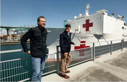  ?? AP ?? California Governor Gavin Newsom, left, and Los Angeles
Mayor Eric Garcetti welcome the US Navy hospital ship USNS Mercy at the Port of Los Angeles yesterday. The 1000-bed ship is expected to provide relief for hospitals overwhelme­d by the coronaviru­s pandemic.