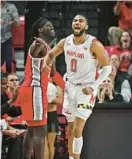  ?? KENNETH K. LAM/BALTIMORE SUN ?? Maryland’s Don Carey, right, reacts in jubilation in front of Ohio State’s Isaac Likekele after forcing a turnover in the second half.