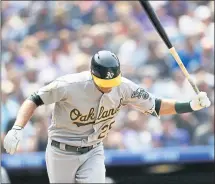  ?? DAVID ZALUBOWSKI — THE ASSOCIATED PRESS ?? The A’s Stephen Piscotty slams his bat after flying out in the seventh inning Sunday. They scored only four runs in three games at Coors Field.