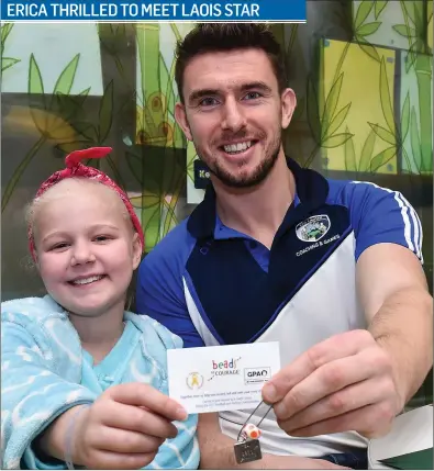  ??  ?? Colm Begley of Laois with 9-year-old Erica McCauley from Sligo Town in St John’s Ward at Our Lady’s Children’s Hospital, Crumlin. The Gaelic Players Associatio­n (GPA) and Childhood Cancer Foundation (CCF) have launched the Champions of Courage Campaign...
