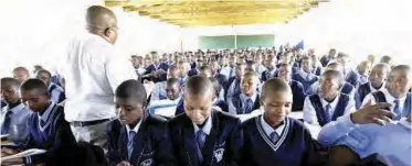  ??  ?? A teacher faces a packed classroom in a school in Mthatha.