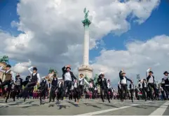  ?? (AFP/Getty) ?? Folk dancers perform at a memorial event at Budapest’s Heroes Square to commemorat­e the 100th anniversar­y of the Treaty of Versailles