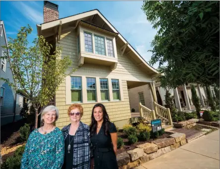  ?? RUSTY HUBBARD/RIVER VALLEY & OZARK EDITION ?? Julie Adkisson, from left, Mary Mosley and Lindsay Henderson stand in front of the Conway Symphony Orchestra Guild’s 2014 Designer House, which is a fundraiser for the symphony. The home is in The Village at Hendrix and is owned by Marilyn and Len...