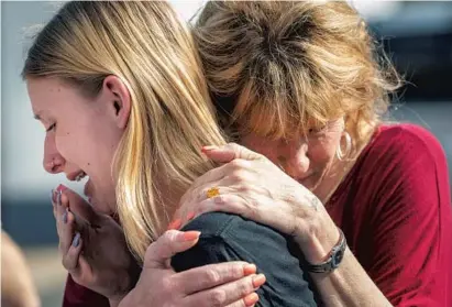  ?? STUART VILLANUEVA/AP ?? Santa Fe High School student Dakota Shrader is comforted by her mother, Susan Davidson, after the shootings at the school on Friday. Shrader said a friend was one of those shot.