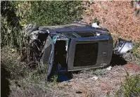  ?? Ringo H.W. Chiu / Associated Press ?? Tiger Woods was rescued Tuesday in Rancho Palos Verdes, Calif., from a single-car crash that sent the golfer into surgery.