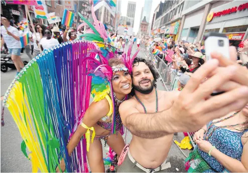  ?? GEOFF ROBINS / AFP / GETTY IMAGES ?? A dancer poses for a selfie during Toronto’s Pride Parade. The city’s gay scene in the ’ 70s was a much different one.