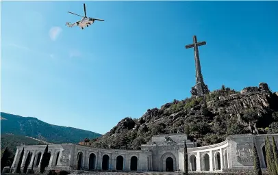  ?? AP ?? A military helicopter carrying the coffin with the remains of Spanish dictator General Francisco Franco overflies the Fallen mausoleum near El Escorial, on the outskirts of Madrid.