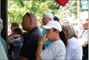  ?? Arkansas Democrat-Gazette/THOMAS METTHE ?? People listen to Chief Deputy Zach Alexander with the Stone County sheriff’s office during a news conference Thursday at the courthouse in Mountain View regarding the shooting that left Sgt. Mike Stephen and a suspect dead.