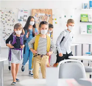  ??  ?? Children should be back in the classroom this month, and while they will not have to wear masks there have been warnings about bullying, such as deliberate coughing