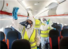  ??  ?? Clean sweep...easyJet workers disinfect a plane before flights resume