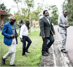  ??  ?? Kabila (second rigt) walks at his personal ranch in Kinshasa. — AFP photo