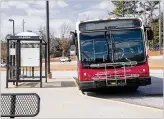  ?? ALYSSA POINTER / ALYSSA. POINTER@AJC. COM ?? A Gwinnett County Transit bus waits for passengers last month at the Gwinnett Transit Center in Duluth.