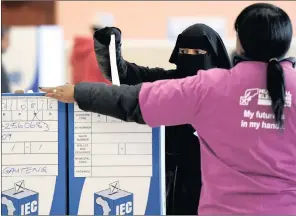  ??  ?? A woman casts her vote at the IEC voting centre at the Nirvana Primary School in Lenasia.