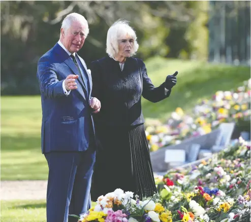  ?? JEREMY SELWYN/POOL/AFP VIA GETTY IMAGES ?? Prince Charles and Camilla, Duchess of Cornwall, visit the gardens of Marlboroug­h House in London on Thursday to view the flowers and messages of condolence left by members of the public following the death of Prince Philip.