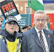  ?? ?? Michael Gove is escorted through Victoria station in London after being heckled by protesters