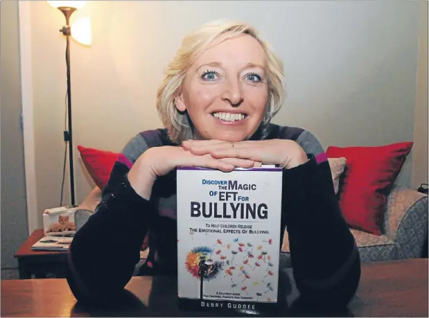  ?? Photo: KRIS DANDO ?? Tapping teacher: Debby Guddee with her book Discover the Magic of EFT for Bullying.