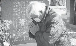  ?? YUICHI YAMAZAKI/GETTY ?? Takao Fujisaki prays Thursday in Namie, Japan, on the 10th anniversar­y of an earthquake that spawned a tsunami. Fujisaki lost his daughter and grandson.