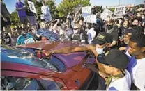  ?? MIKE SIMONS AP ?? Protesters surround a truck shortly before it drove through the group, injuring several, in Tulsa, Okla., on May 31.