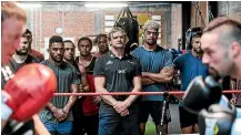  ?? PHOTOSPORT ?? Crusaders coach Scott Robertson, centre, looks on as Joseph Parker, right, and his trainer, Kevin Barry work out during a training session in Christchur­ch.