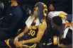  ?? RICK BOWMER — THE ASSOCIATED PRESS ?? Golden State Warriors guard Stephen Curry sits on the bench in the second half Saturday against the Utah Jazz in Salt Lake City.