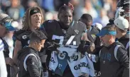  ?? COREY PERRINE/FLORIDA TIMES-UNION ?? Jaguars OT Cam Robinson (74) tears up after an apparent injury as QB Trevor Lawrence pats him on the head.