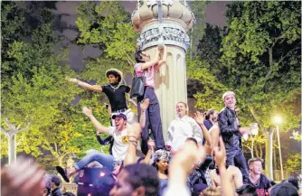  ?? NACHO DOCE • REUTERS ?? People gather in a “macrobotel­lon” (drinking and dancing session) on a street on Monday, as the state of emergency decreed by the Spanish government to prevent the spread of COVID-19 is lifted in Barcelona.