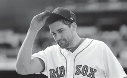  ?? Jim Rogash, Getty Images ?? The Boston Red Sox geared up for the stretch run by picking up starting pitcher Nathan Eovaldi, above, shown heading for the dugout Sunday after pitching against the Minnesota Twins.