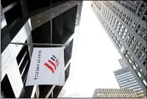  ??  ?? In this file photo photo, a Bank of America flag waves in front of the Bank of America Financial Center building in Boston. Bank of America reports
financial results, Jan 15. (AP)