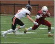  ?? RANDY MEYERS — FOR THE MORNING JOURNAL ?? Oberlin’s Kobe Brooks attempts to avoid a tackle attempt by Nick Lang of Kalamazoo during a punt return Sept. 4.