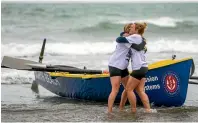  ??  ?? Georgia Perry and Emma Sherratt celebrate their efforts after rowing from Akaroa to North Beach in fewer than 12 hours.