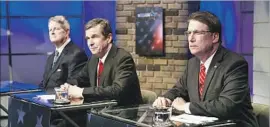  ?? Chris Seward Charlotte Observer ?? NORTH CAROLINA Gov. Pat McCrory, right, is in a tight contest with Democrat Roy Cooper, center. Pictured at left in a recent debate is Libertaria­n Lon Cecil.