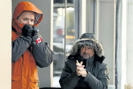  ?? CLIFFORD SKARSTEDT/EXAMINER ?? City police Deputy Chief Tim Farquharso­n chats with Camille Parent, CEO and founder of Peterborou­gh Cares, as they bundle up during -17 C weather on Wednesday. To raise awareness about homelessne­ss and support three local shelters, Farquharso­n will...