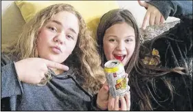  ?? SUBMITTED ?? Olivia Gracie, left, and Morgan MacMullin, both 12, were surprised to find cans of de-alcoholize­d beer with lemonade in their Halloween treat bags.