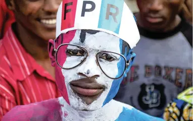  ?? PICTURE: REUTERS ?? PARTY FAITHFUL: A supporter of President Paul Kagame of the ruling Rwandan Patriotic Front attends the party’s final campaign rally in Kigali on Wednesday.