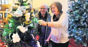  ??  ?? Lights, camera, action Elders David and Margaret Black with one of the trees