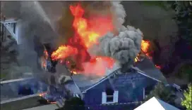  ?? ASSOCIATED PRESS PHOTOS ?? Flames consume a home in Lawrence, Mass., a suburb of Boston, on Thursday. Emergency crews responded to what they believed to be a series of gas explosions that damaged homes across three neighborin­g communitie­s.