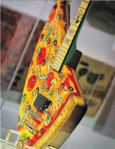  ?? PHOTOS: BEBETO MATTHEWS/THE ASSOCIATED PRESS ?? The Pizza Guitar, from musician Andrew W.K., is part of an exhibition celebratin­g pizza.