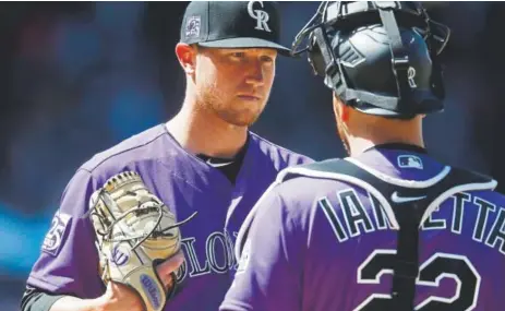  ?? Associated Press file ?? Rockies starter Kyle Freeland, above visiting with catcher Chris Iannetta on the mound, says one of his main goals is to reduce walks. He’s beginning to accomplish that goal. He’s averaging 3.13 walks per nine innings, compared with 3.33 last season.