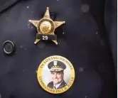  ?? SUN-TIMES FILES ?? A Chicago police officer wears a pin bearing the image of Cmdr. Paul Bauer, who was shot and killed on Feb. 13, 2018.