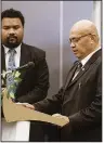  ?? (AP/Tuvalu government) ?? Newly elected Prime Minister Feleti Teo (right) is sworn into office during a ceremony on Wednesday in Funafuti, Tuvalu.