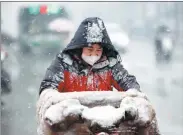  ?? WANG YONGBO / FOR CHINA DAILY ?? A resident of Shijiazhua­ng, Hebei province, commutes as the city’s first snow of the year fell on Feb 9. Weather forecaster­s said temperatur­es could drop by 4 to 8 C over most parts of central and eastern China in the following days.