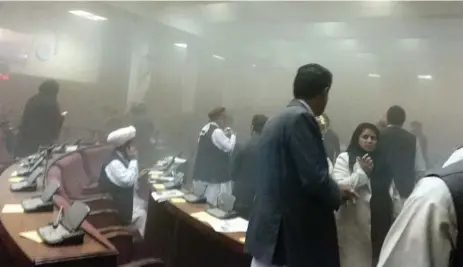  ?? DR. NAQIBULLAH FAIQ/THE ASSOCIATED PRESS ?? In this photo taken by Dr. Naqibullah Faiq, an Afghan member of Parliament, lawmakers leave the main hall after a suicide attack on Monday.