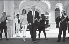  ??  ?? US President Donald Trump and First Lady Melania Trump greet a marching band as they arrive at Trump Internatio­nal Golf club to watch the Super Bowl LI between New England Patriots and Atlanta Falcons in West Palm Beach, Florida, US, February 5, 2017....