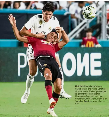  ?? — AFP ?? Gotcha!: Real Madrid’s Jesus Vallejo (back) and Alexis Sanchez of Manchester United get tangled up during the Internatio­nal Champions Cup match at Hard Rock Stadium in Miami, Florida, on Tuesday. Top: Jose Mourinho.