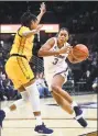  ?? Stephen Dunn / Associated Press ?? UConn’s Megan Walker drives around Cal’s Jaelyn Brown during a game in March.